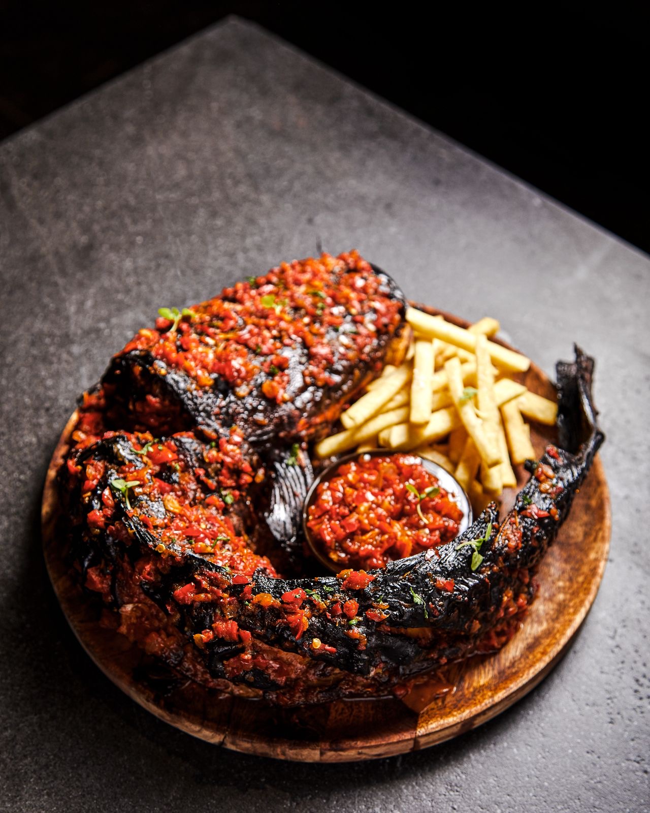 Grilled cat fish with with fries and a side of pepper sauce